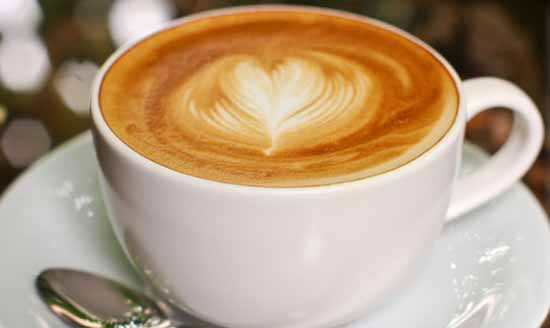 Menu-Images-Coffee Hot Chocolate in a tea cup with a light frosting on top in the shape of a heart