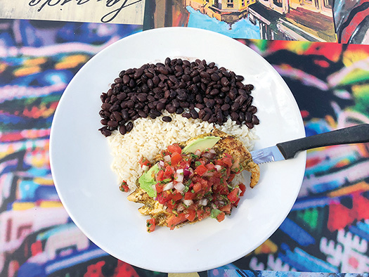 Cilantro Lime Chicken with rice and black beans on a white plate.